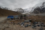 Porters break up a crashed helicopter to take down in peices