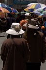 Pilgrims with prayer wheels passing by